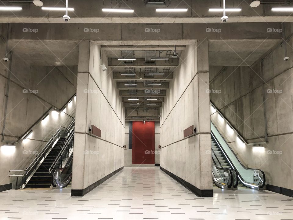 long gray corridor with red background