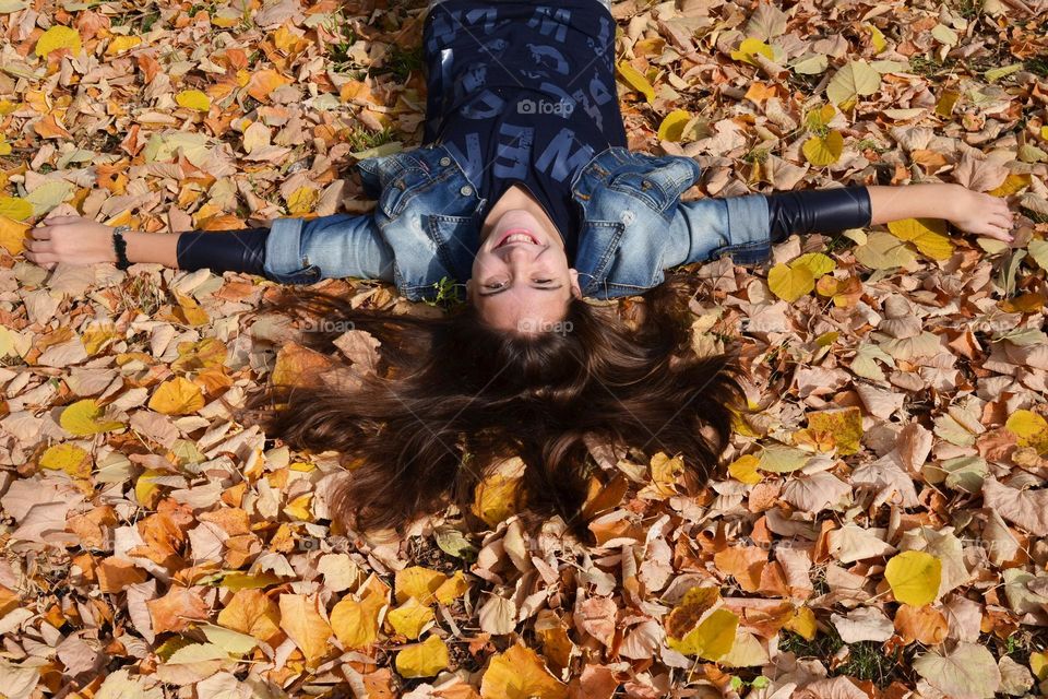 Smiling Young Girl on Autumn Background