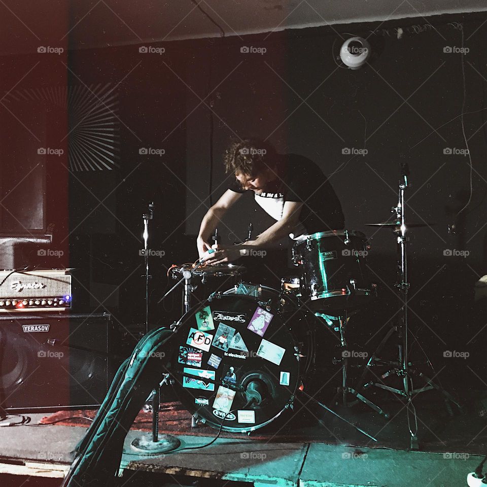 The drummer is preparing for the concert