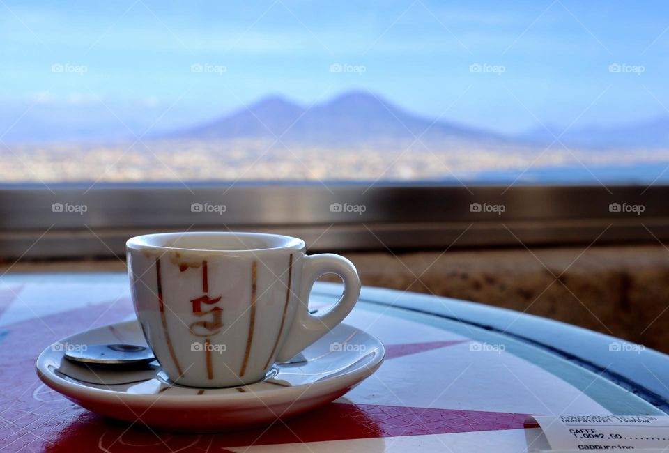 Espresso cup on the table in cafe on st. Elmo viewing Volcano Vesuvius and Napoli 