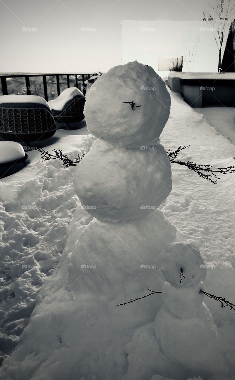 Snowman and snow baby chilling on the balcony 
