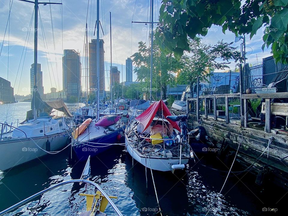 This is beautiful “Newtown Creek” by the “Pulaski Bridge” in LIC, Queens with its tremendous variety of boats tied to the shore and a handcrafted wooden veranda on land where sometimes parties are being held. 2023. Hypnotic Productions