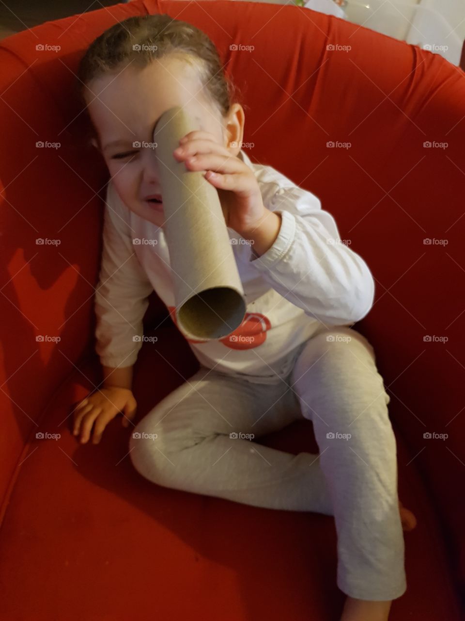 a little girl play with a cardboard