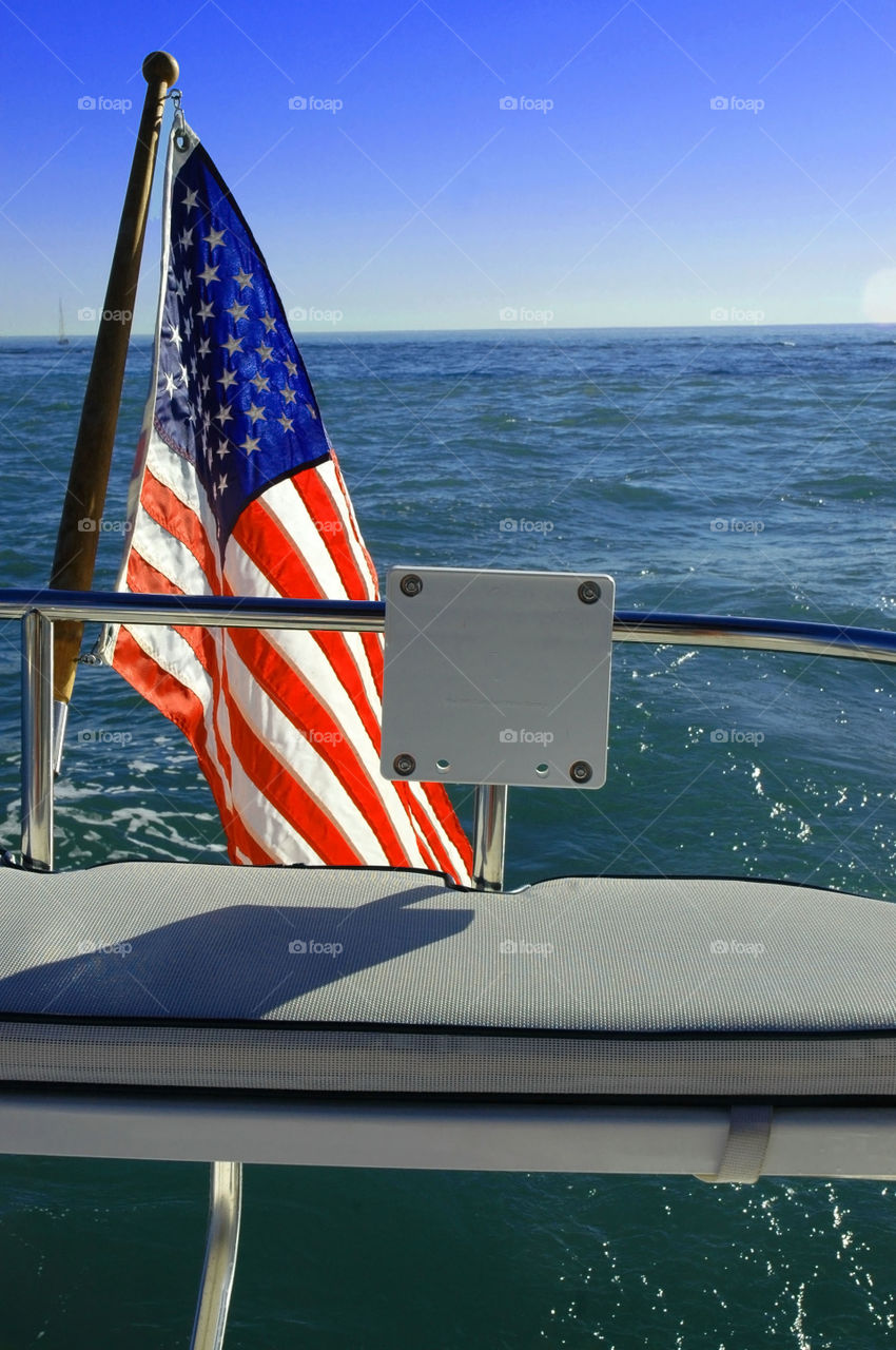 American flag on the back of a sailing boat in Newport California.