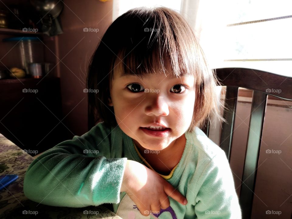 Portrait of an adorable child from the north eastern state of India.This shot is all about natural light photography.