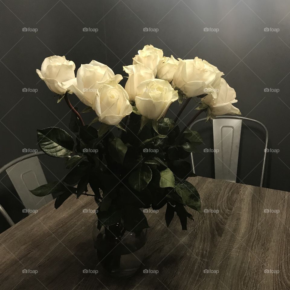 White roses displayed on a table