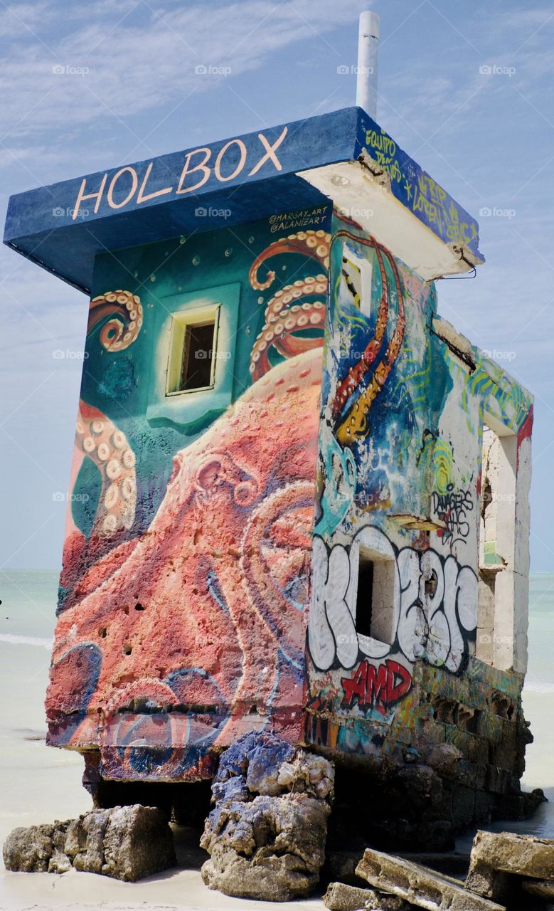 Street art on a partially collapsed cement tower.