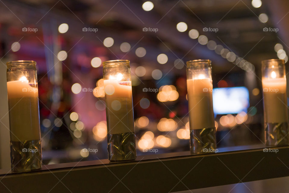 Glowing candles at a holiday party with selective focus