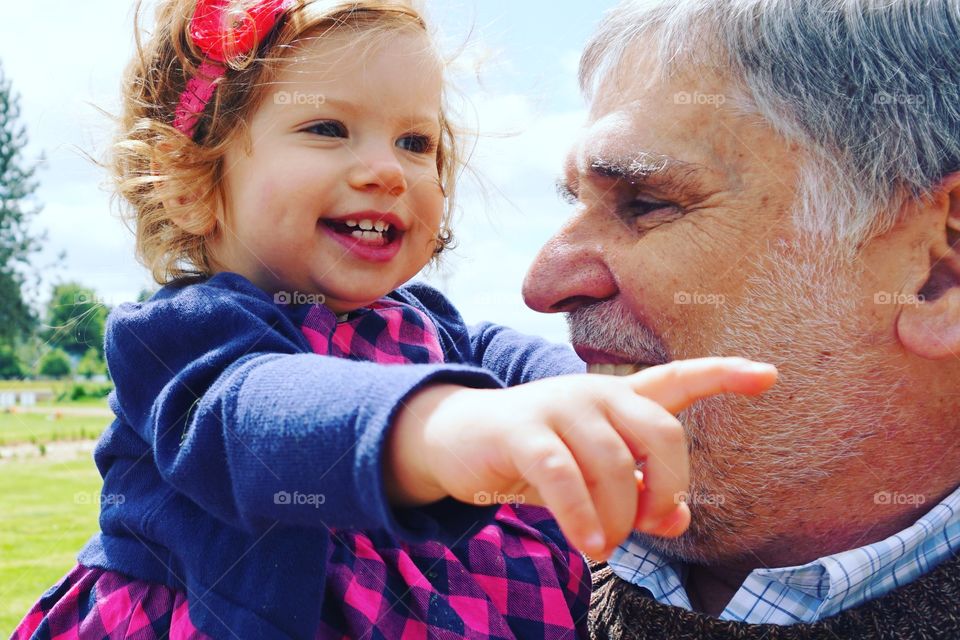 Smiling grand father with grand daughter