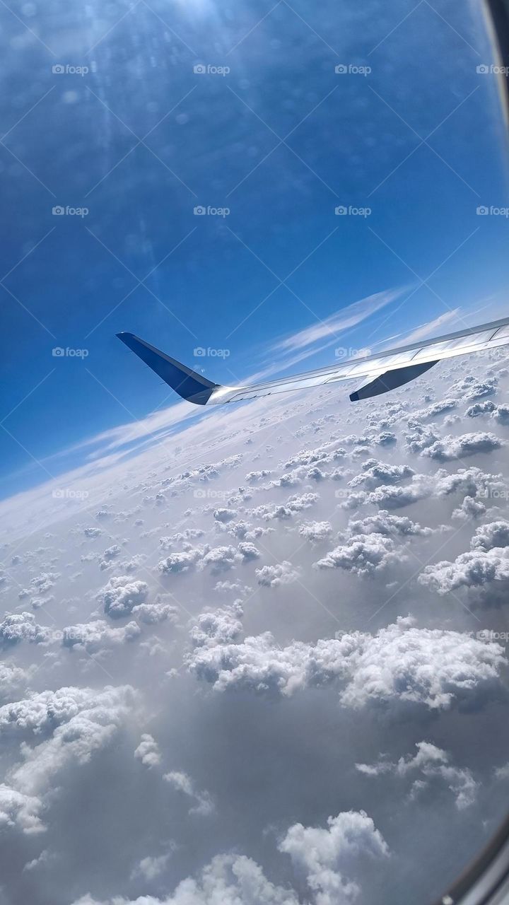 View of clouds from aeroplane window.