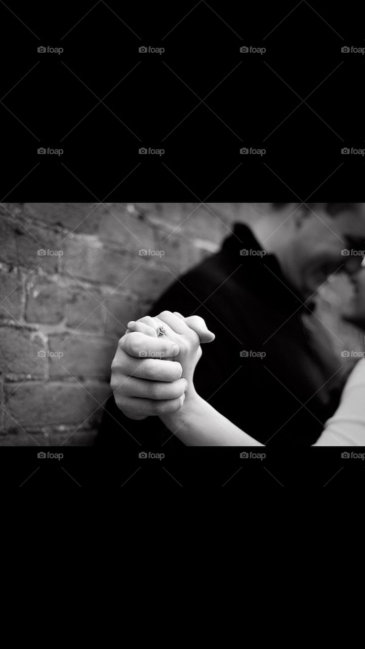 Black and white photo of a couple holding hands