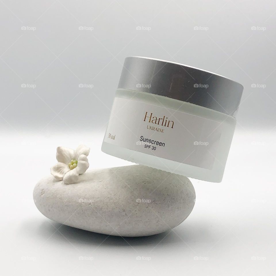 jar of cream on a stone object on a stone object photo cosmetics cream sun sreen face cream face cosmetics sun protection