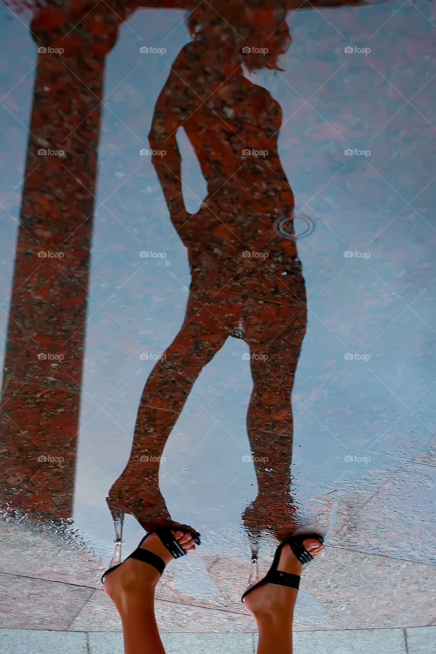 Shadow and reflection of a girl in water 