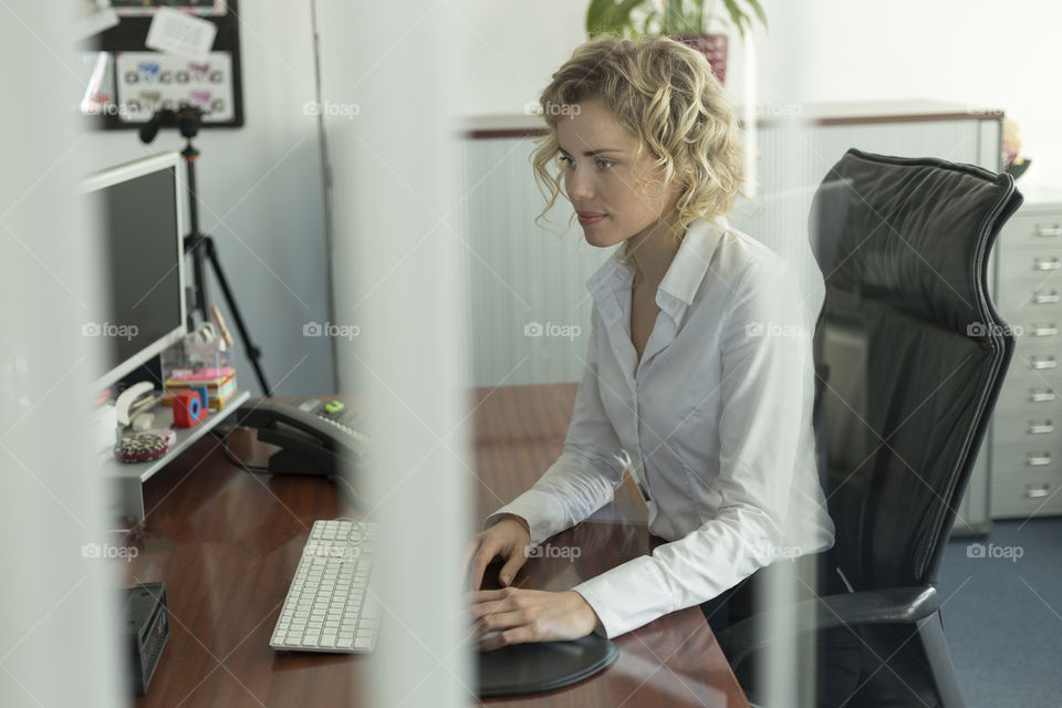 Businesswoman working at laptop in office