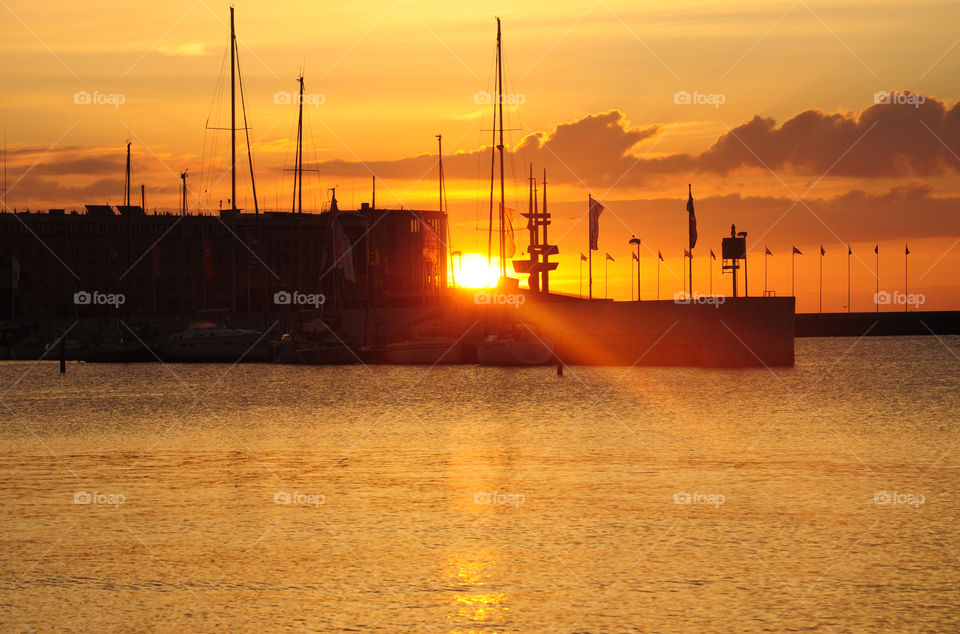 port silhouette during sunrise at the Baltic sea coast in Poland