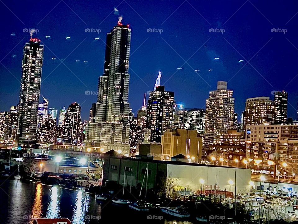 A nighttime view of Long Island City, Queens, NY seen from the Pulaski Bridge looking across from the Greenpoint, Bklyn side standing in the pedestrian lane. 2022. Hypnotic Productions