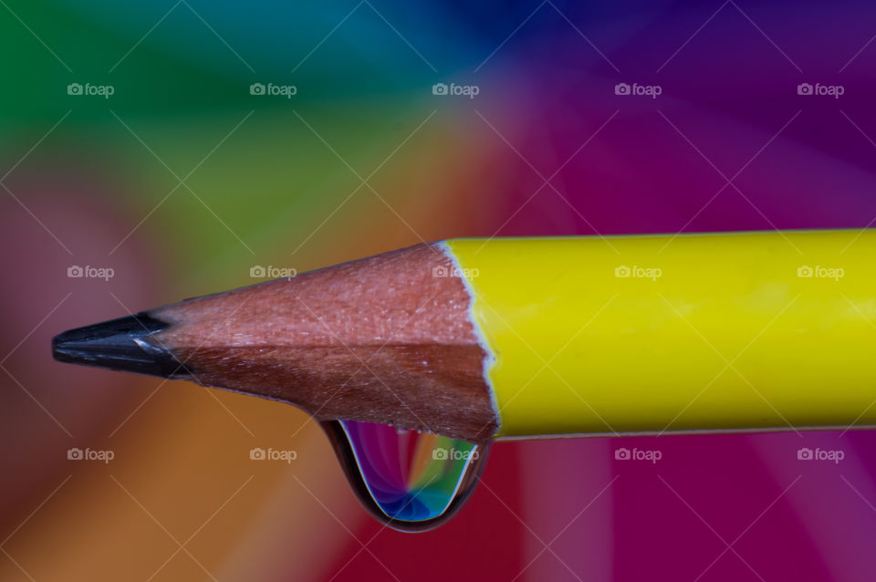 Macro shot of a pencil with water droplet reflecting beautiful colors.