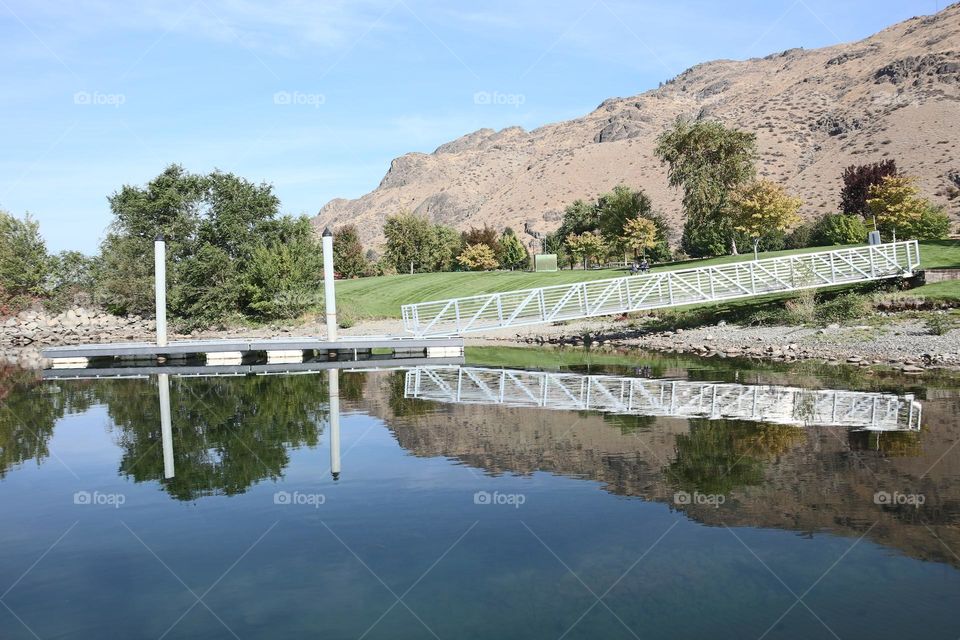 Still waters with reflection of boat launch