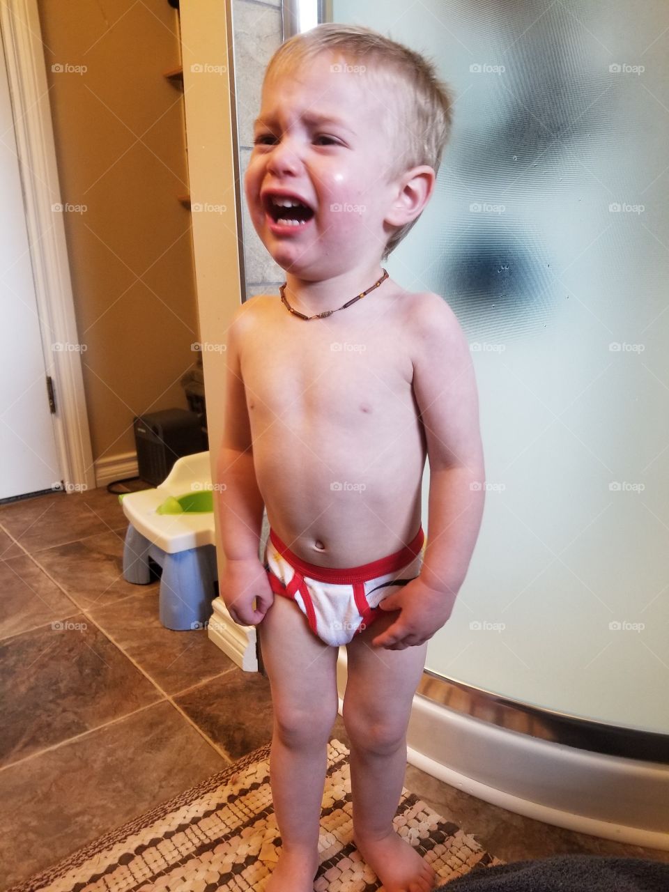 Cute little boy angry by new undies learning to potty train