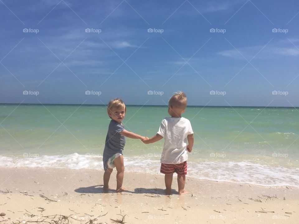 Two children having fun at the beach 