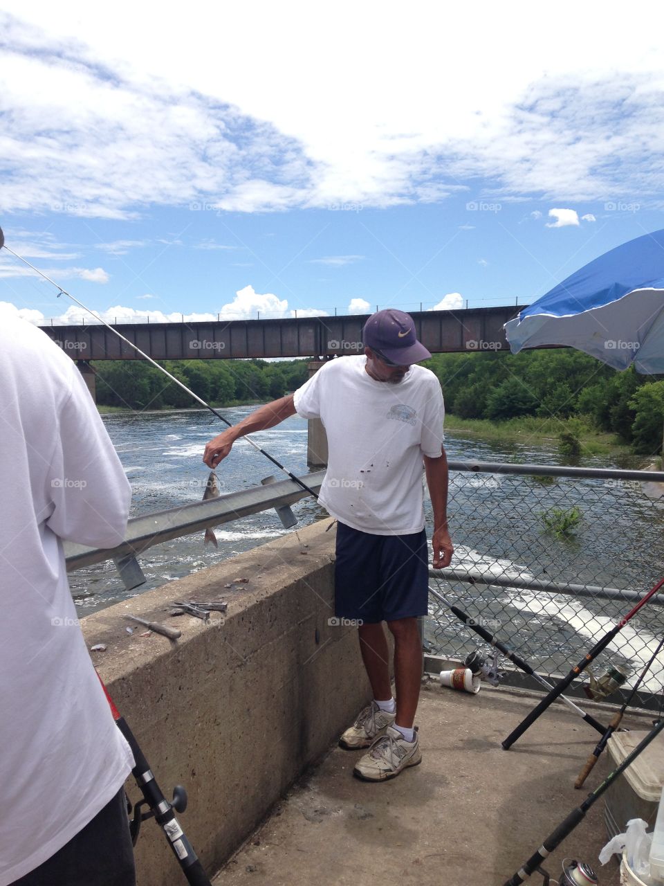 Not a keeper. Man caught a small catfish at the river