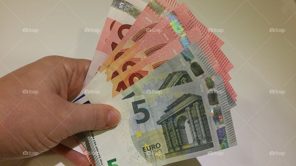 hand holding euro notes