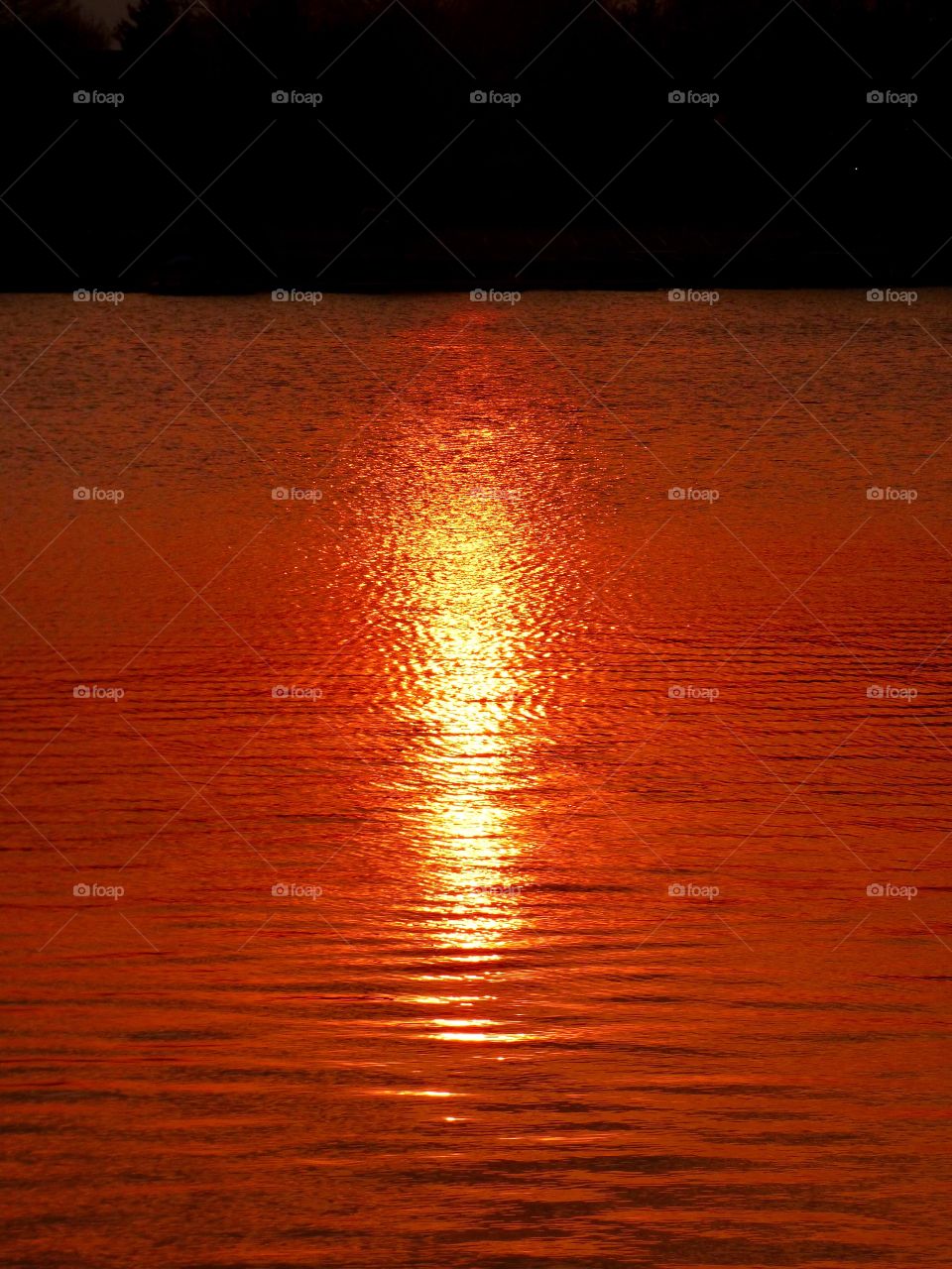 Beautiful sunset on the lake water. 