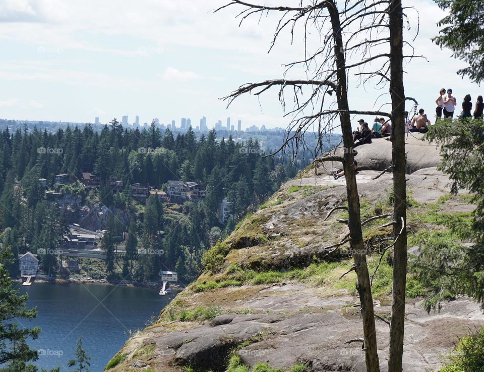 Climb up a mountain with a view of Vancouver in the distance 