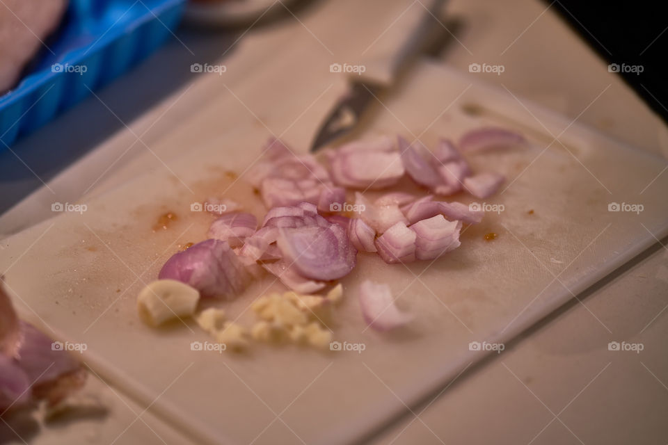 Making tomatoes sauce with onion and garlic