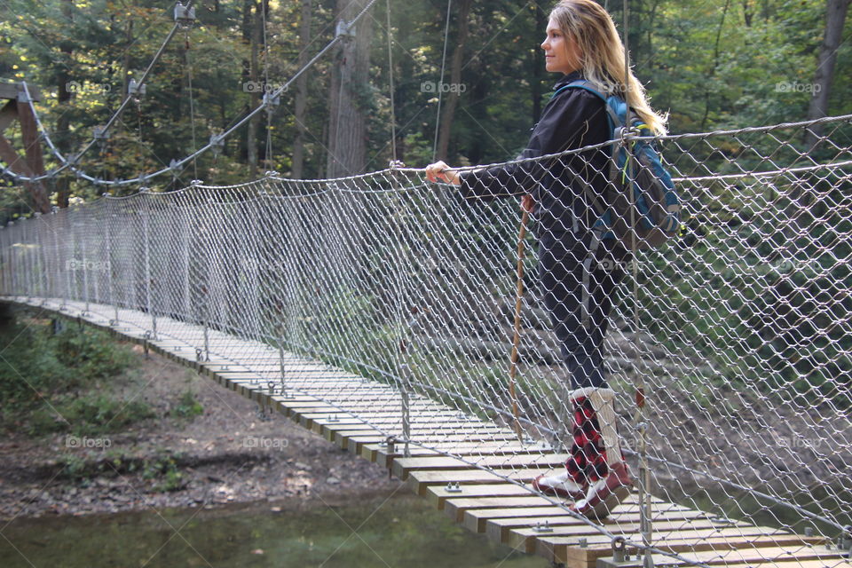 Woman hiking across bridge in Ohio, USA