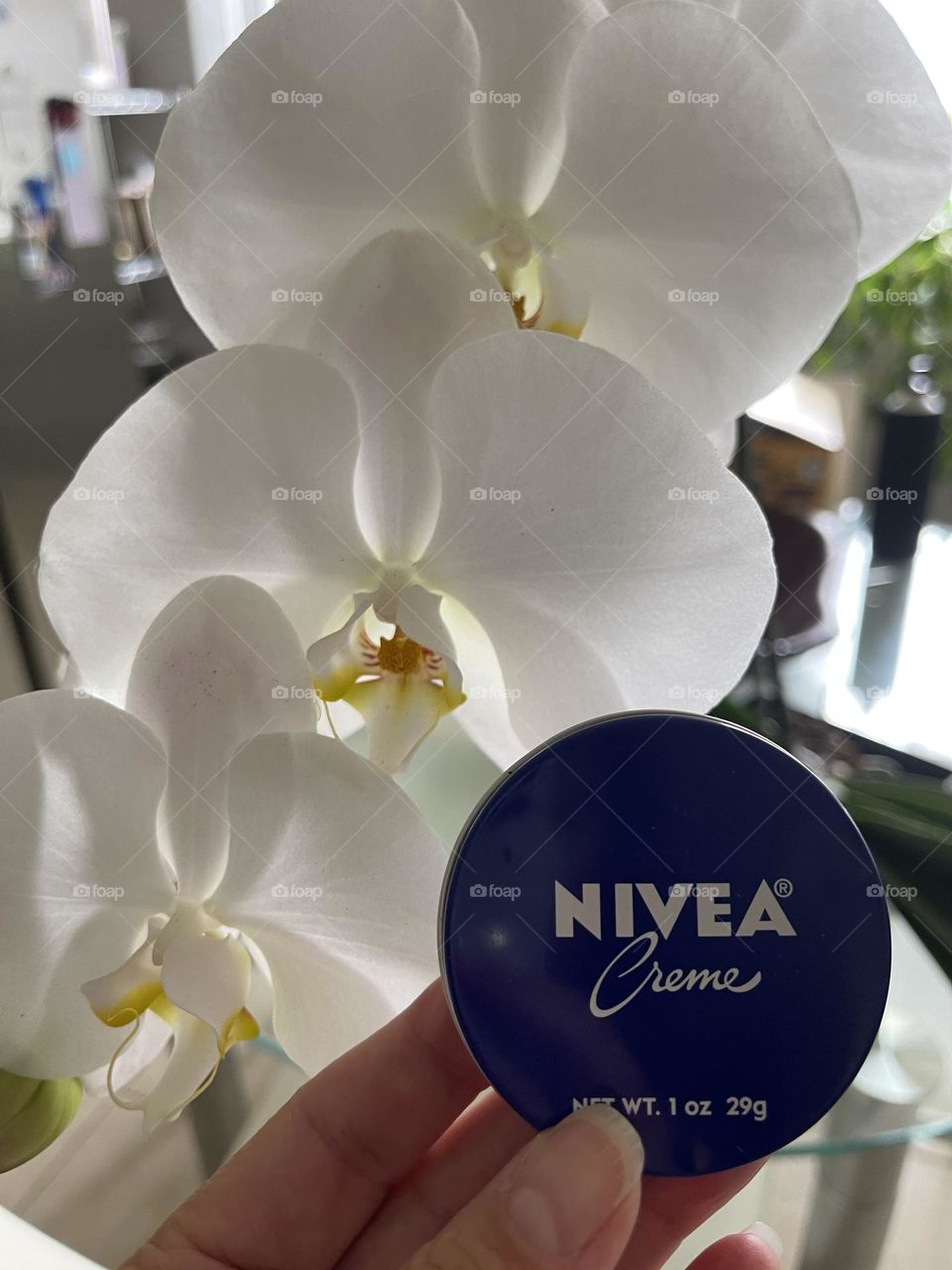 Nivea crème with white orchids.