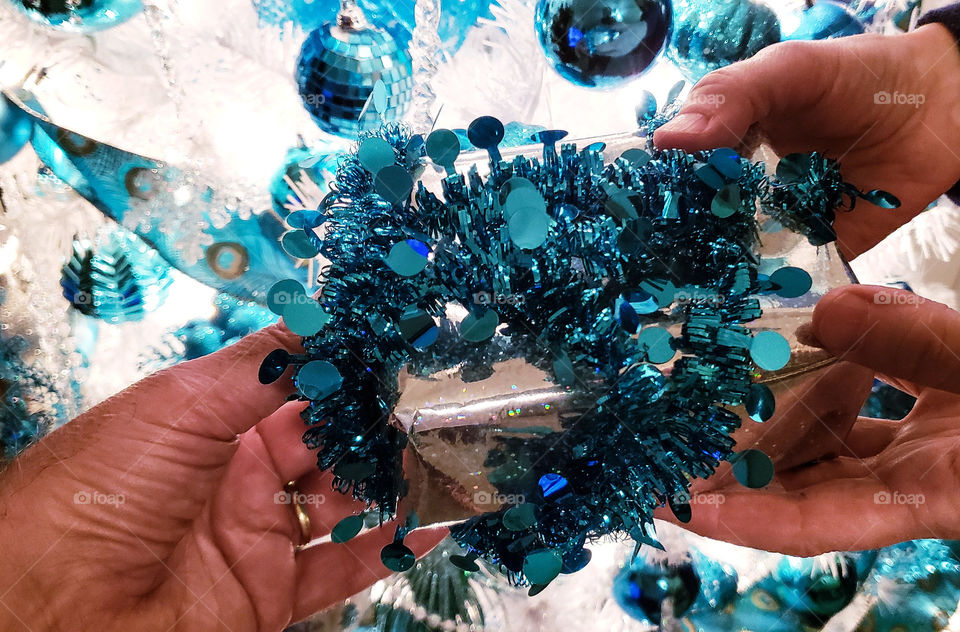 exchanging gifts in front of Christmas tree.