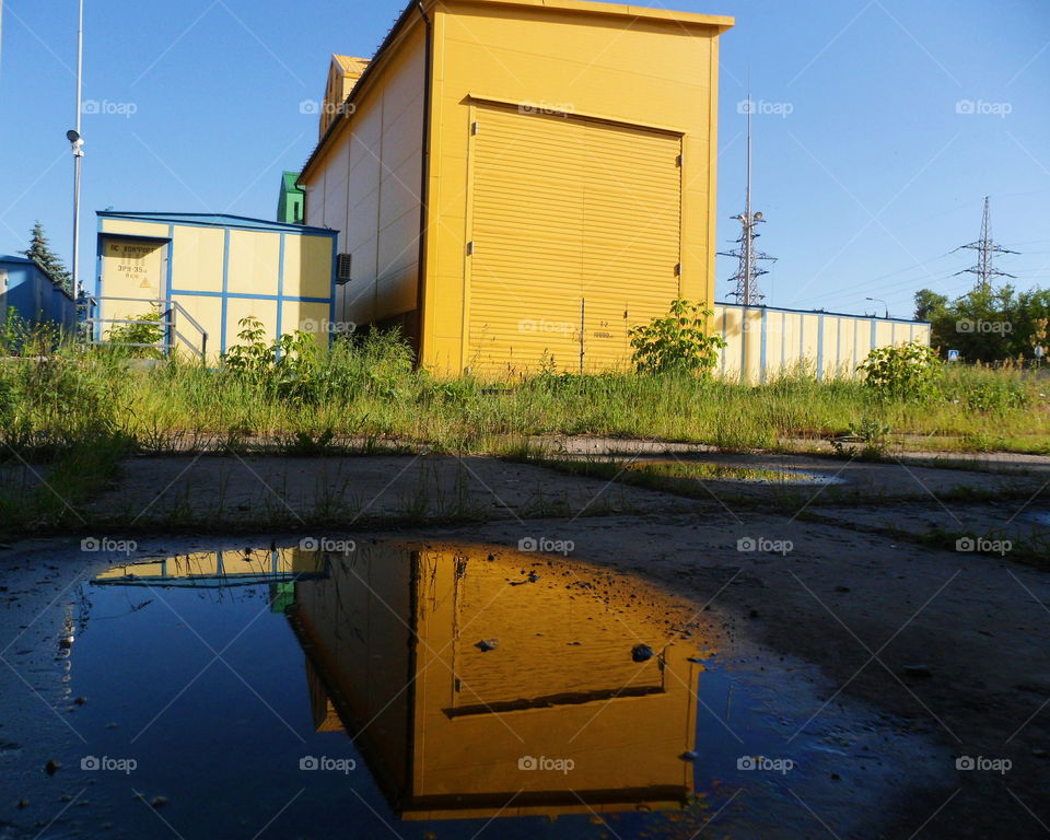 Reflection of a building in a puddle