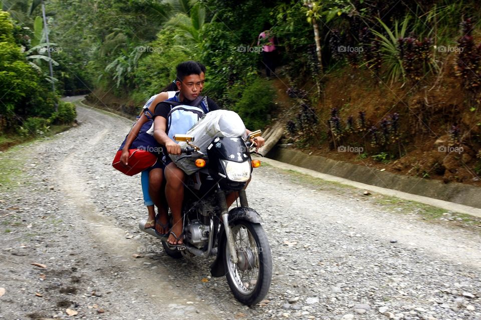 teen agers riding a motorcycle. teen agers riding a motorcycle