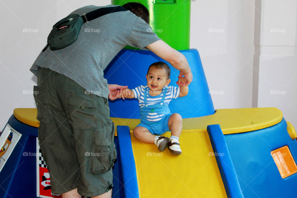 father helping  his son to slide