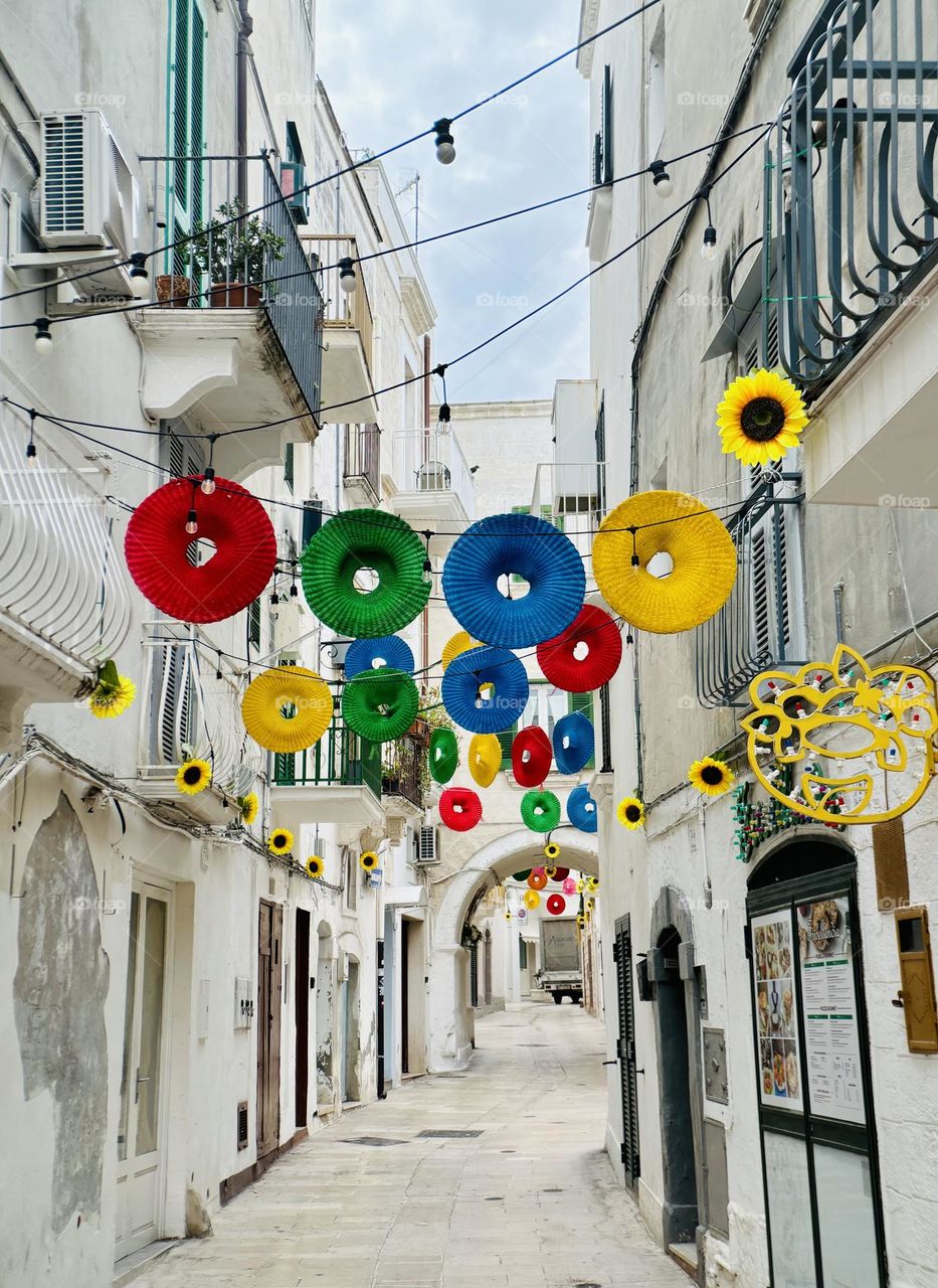 Bright circular decorations against white washed buildings.