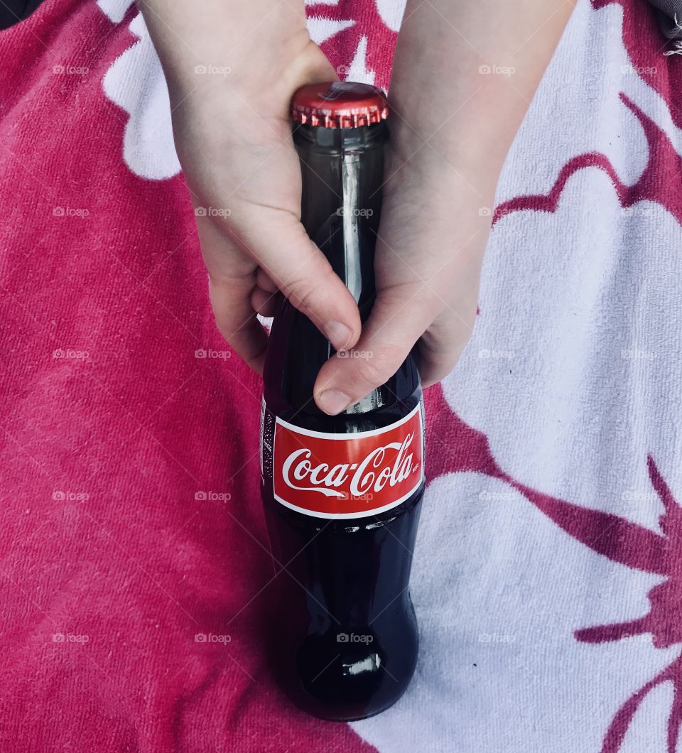 Coca Cola bottle on a beach towel 