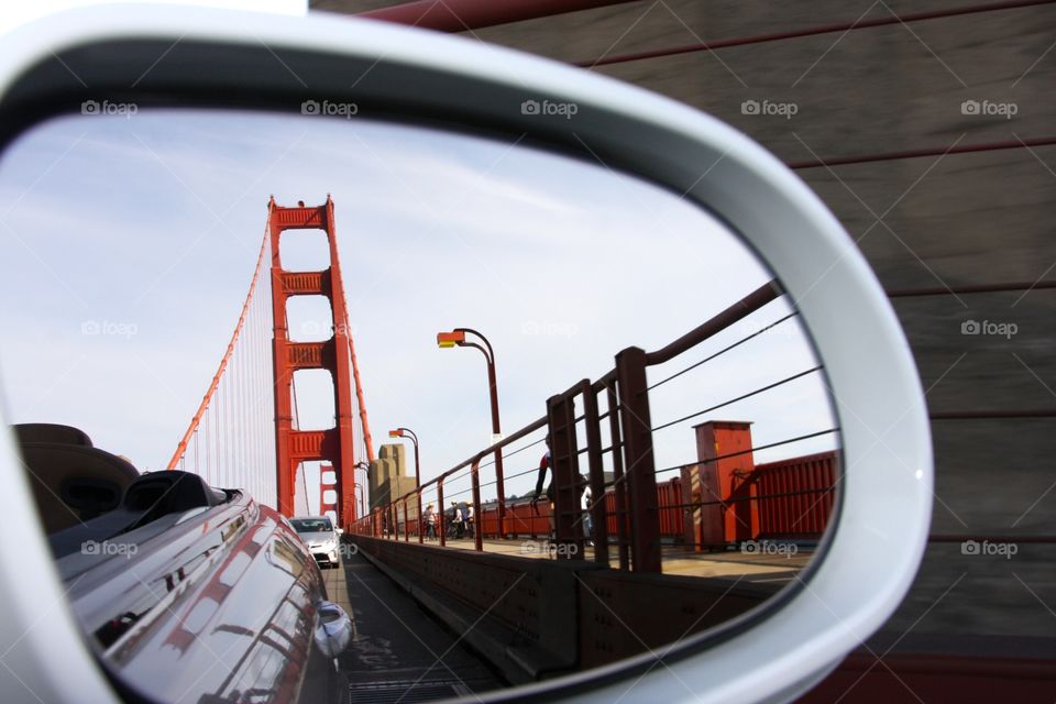 A side mirror view of the commute traffic on the Golden Gate Bridge 