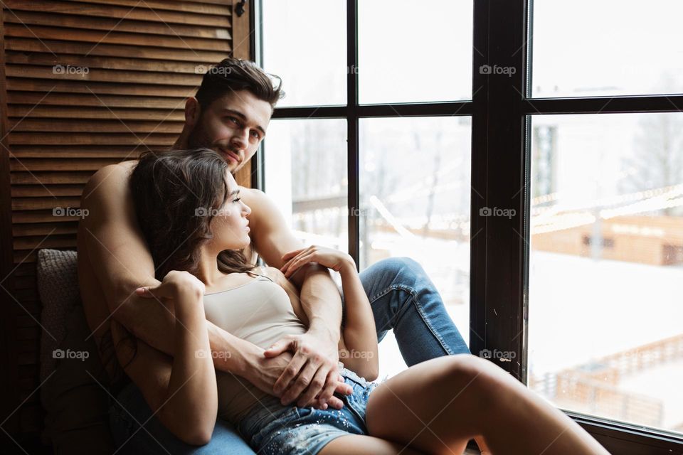 Couple in love near window 