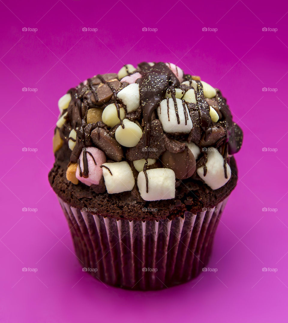 Marshmallow cupcake over pink background