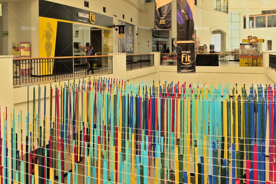 Multicolored paper ornaments on a mall promenade