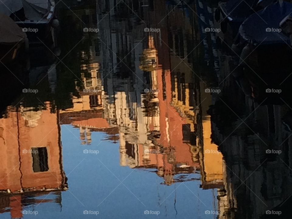 Reflection of houses in the water of a canal. Venice