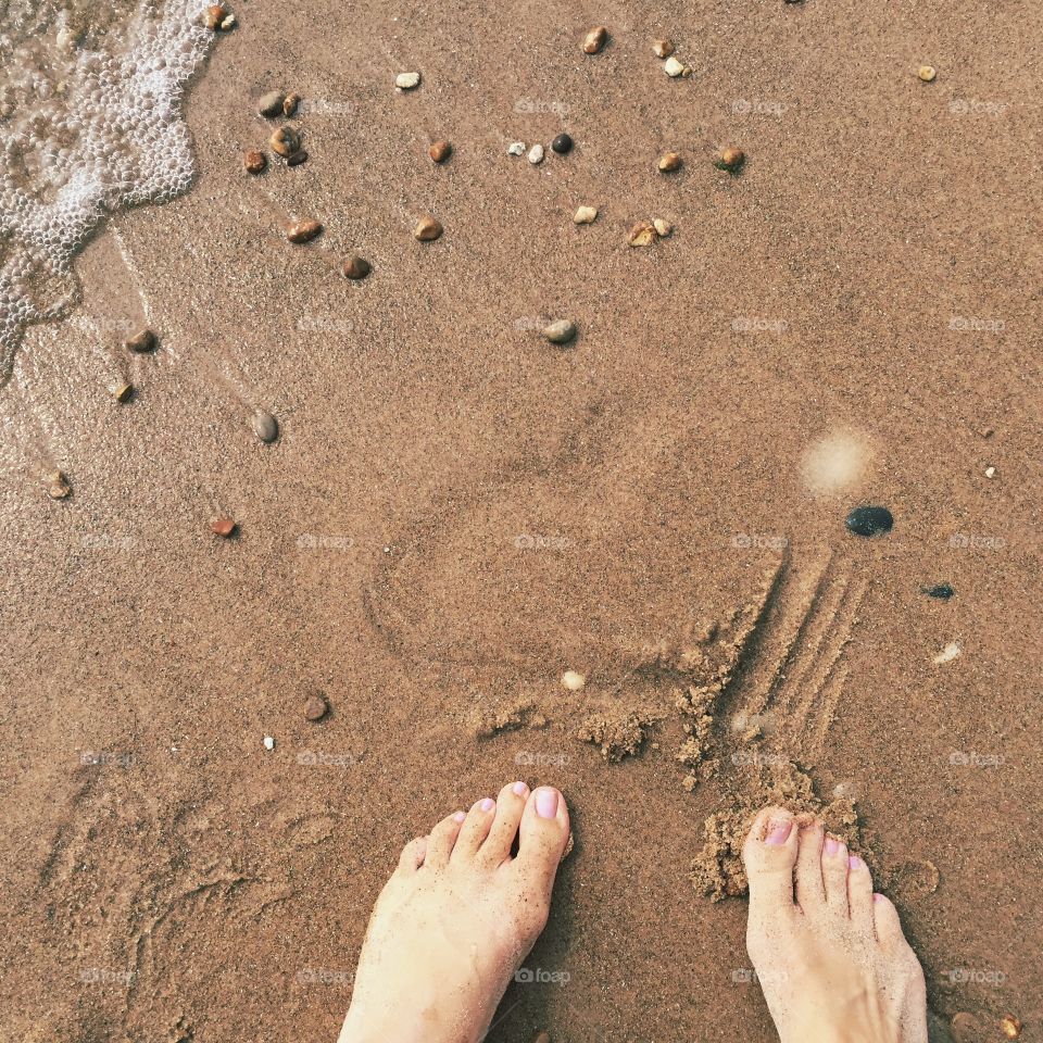 Low section of woman standing on beach