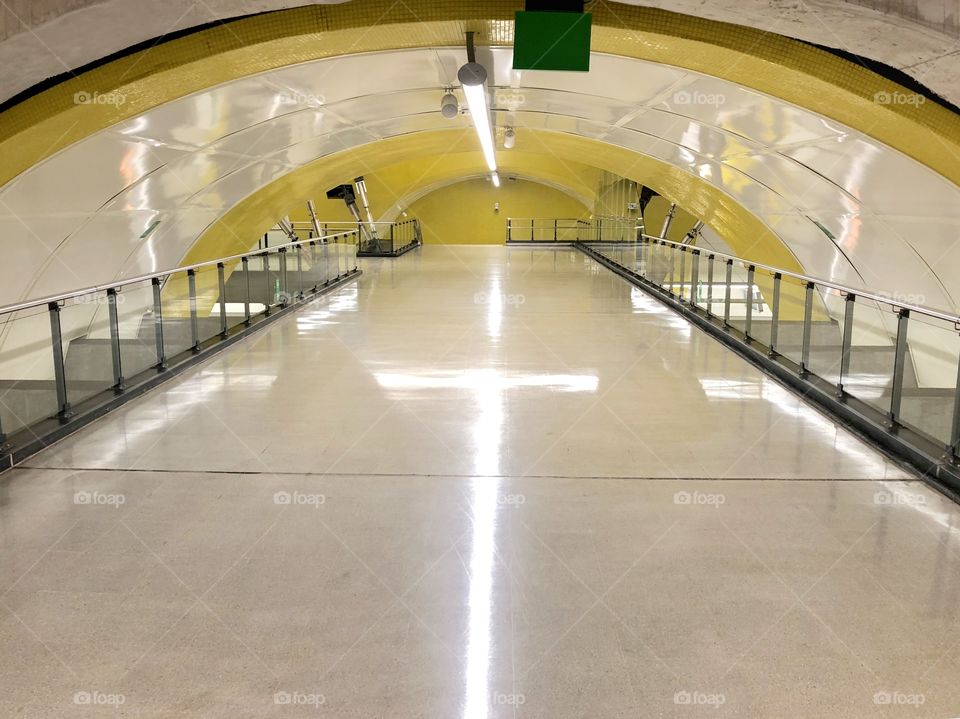 tunnel with yellow details and cross reflection on the ground