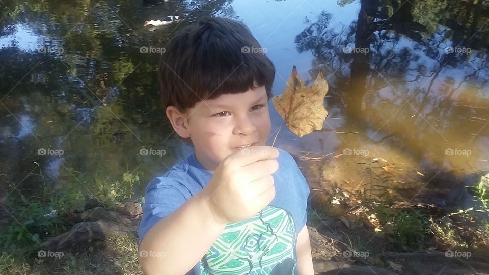 Boy with leaf in park