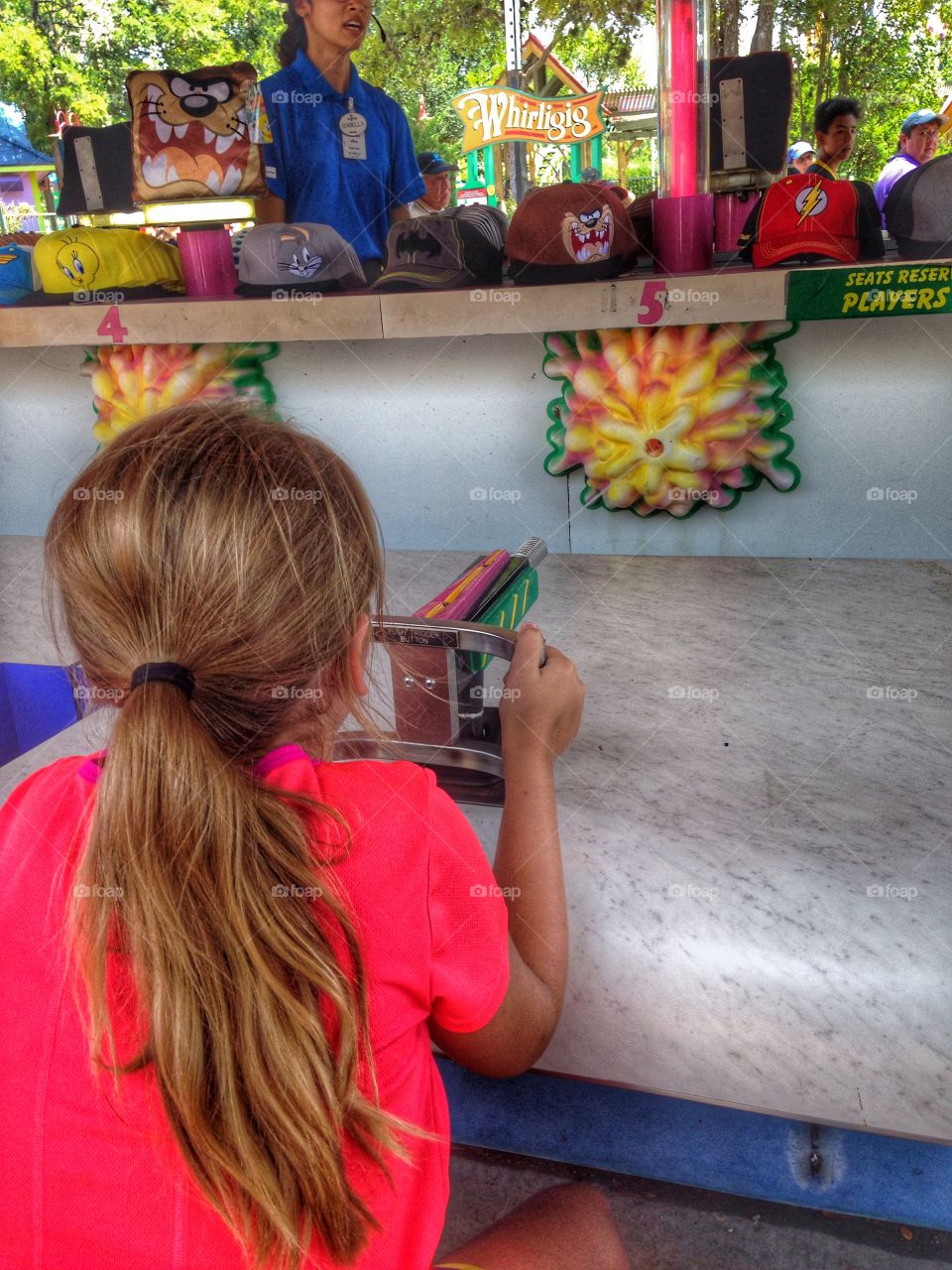 Pick a prize, any prize. Girl playing a carnival game at fiesta Texas 