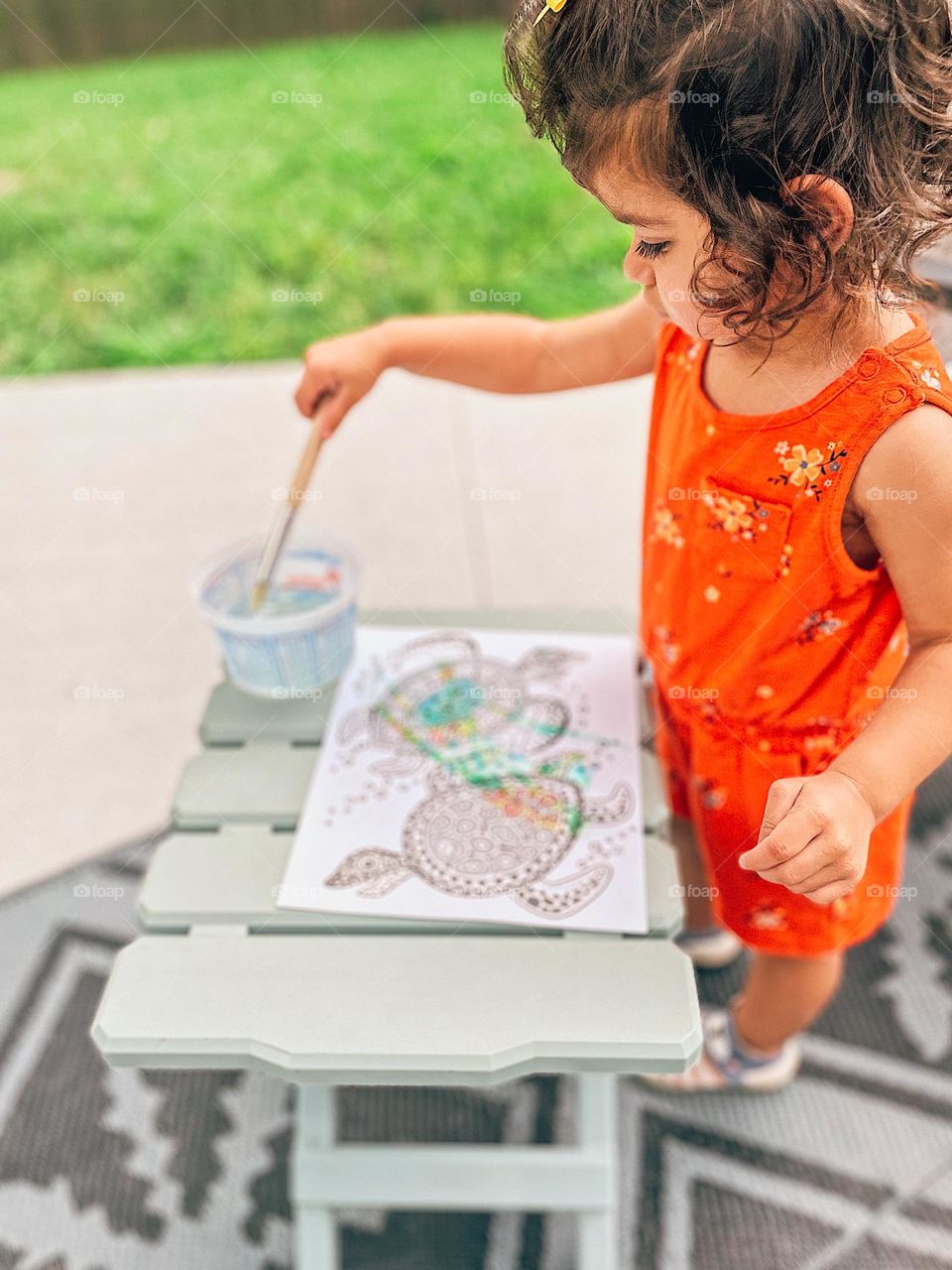 Toddler girl painting sea turtles, crafting with kids, art projects with children, being creative outside, young girl gets creative 