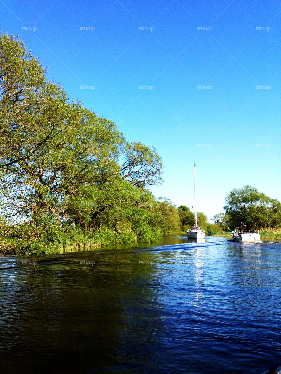 sky boats trees water by joosse_b