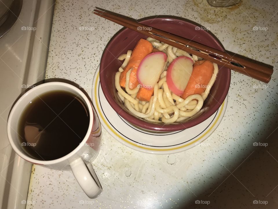 Japanese udon and black coffee ready for consumption late at night. It was light cooking with little preparation involved.