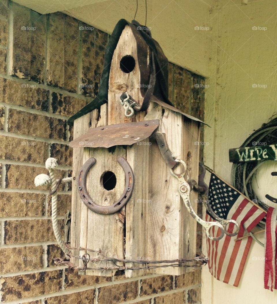 Old fashioned bird house. Bird house made out of scrap wood and scrap metal.